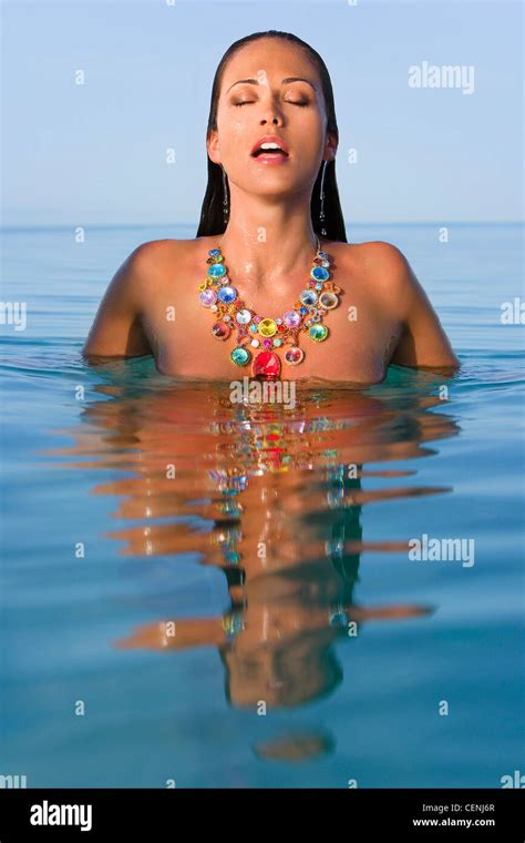 Female Long Wet Brunette Hair Wearing An Oversized Necklace Encrusted