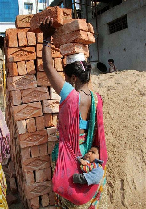 Incredible Image Of Mother Carrying Bricks On Head And Baby On Back