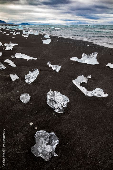 amazing blue colored icebergs washed ashore the black sand beach ...