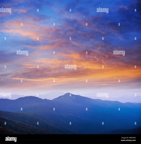 blue color of mountains during sunset Stock Photo - Alamy