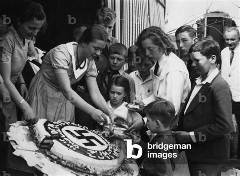 Image of Hitler's birthday cake is being shared, 1934 (b/w photo)