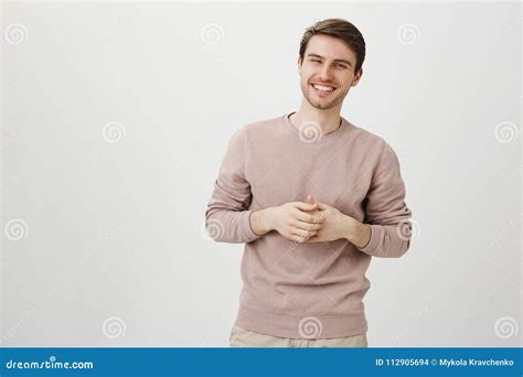 Portrait Of Handsome Athletic Male With Charming Smile Holding Hands