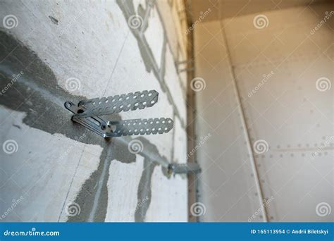 Unfinished Brick Wall In A Room Under Construction Prepared For Drywall