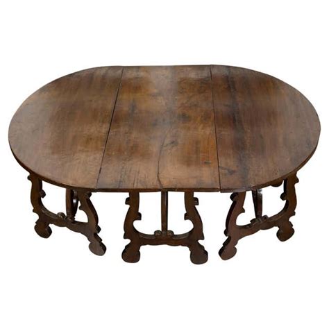 Jour Jali Oval Table In Rainbow Teak Wood Handcrafted In India By Paul