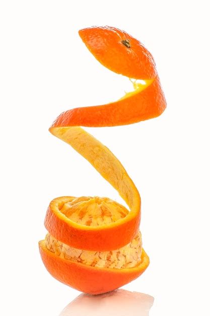 Premium Photo Oranges Peeled In Spiral Shape Isolated