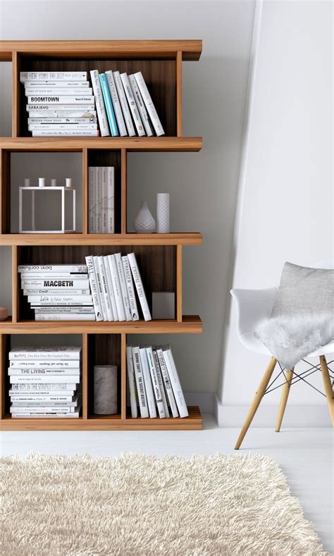 A White Chair Sitting Next To A Book Shelf Filled With Books