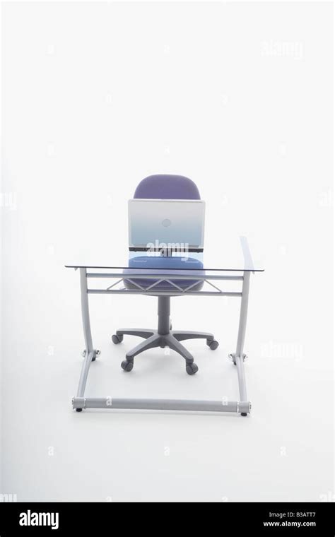 Laptop computer on desk and chair Stock Photo - Alamy