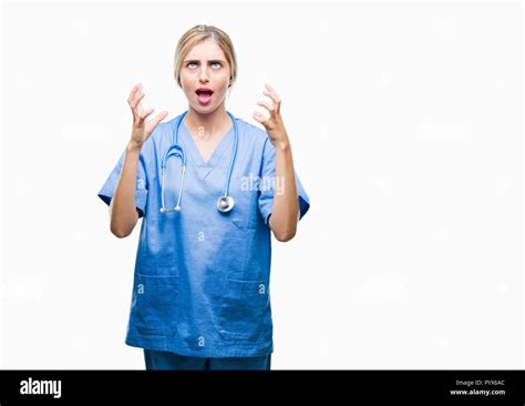 Belle jeune femme blonde infirmière médecin chirurgien sur fond isolé et mad fou criant et