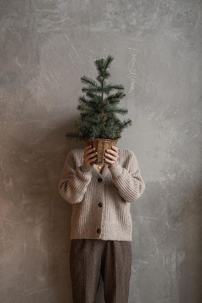 Premium Photo Woman Holding Bucket With Fir Needle Branches Against