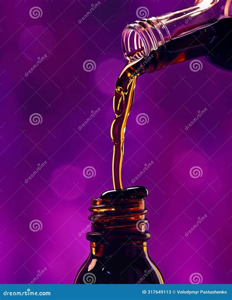 A Bottle Of Liquid Is Being Poured Into A Glass Stock Image Image Of