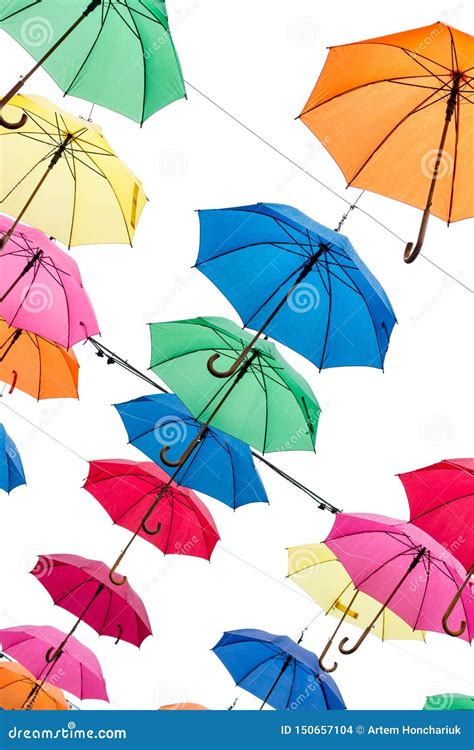 Multicolored Umbrellas Are Suspended On A White Cloudy Sky Background