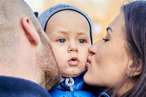 Parents Kissing Their Child · Free Stock Photo