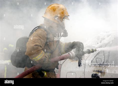 Firefighter Uses CAFS To Extinguish A Car Fire Stock Photo Alamy