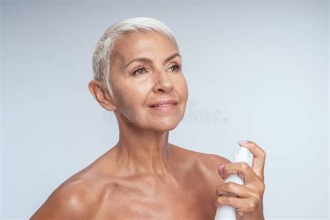 Attractive Woman Spraying Her Body With Thermal Water Stock Photo