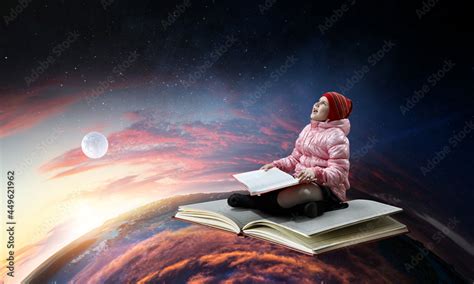 Little girl reading a book Stock Photo | Adobe Stock