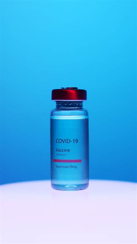 covid  vaccine vial  blue background  stock photo