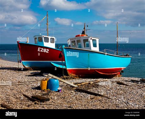 View Of Traditional Fishing Boats Landed On The Steep Shingle Beach At