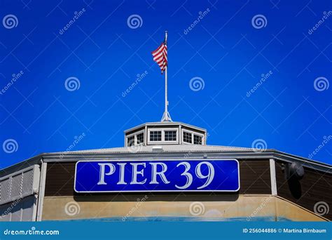 The Famous Pier 39 Sign With American Flag In The Background Editorial