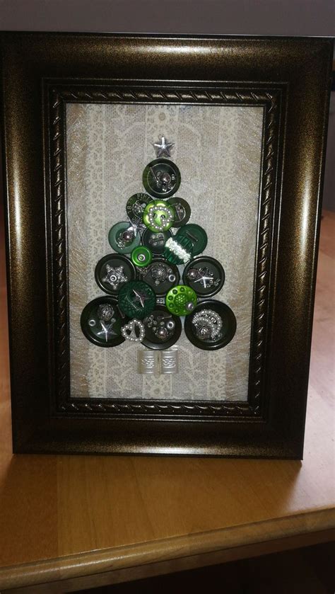 A Christmas Tree Made Out Of Bottle Caps In A Shadow Box On A Wooden Table