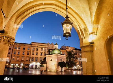 City of Krakow by night in Poland, Ranaissance arch of the Cloth Hall (Sukiennice), St. Adalbert ...