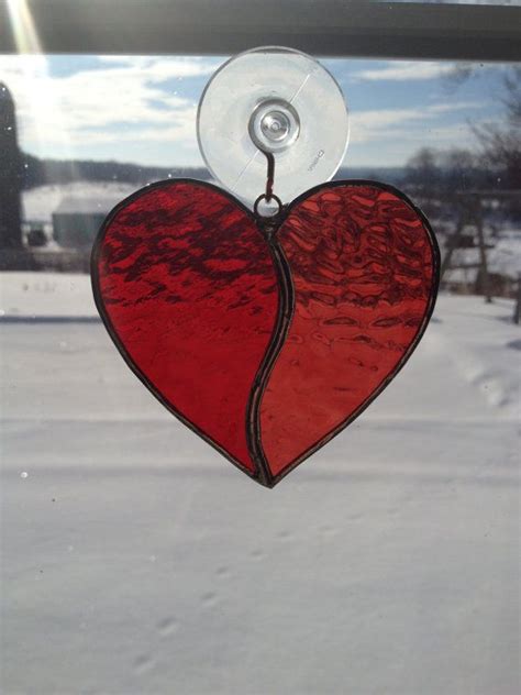 A Stained Glass Heart Hanging From A Window