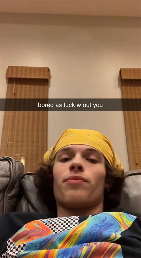 A Man With A Bandana On His Head Sitting In A Chair