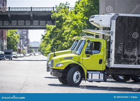 Middle Duty Compact Rig Semi Trucks With Box Trailers Standing On The