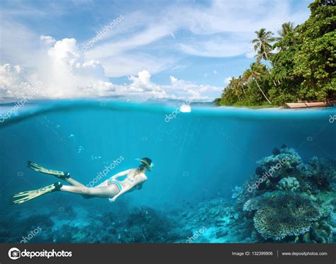 Woman Snorkeling In Clear Tropical Waters In Near Of Exotic Isla