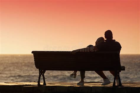 Love Couple Sitting On Bench By The Sea Embracing Stock Image Image