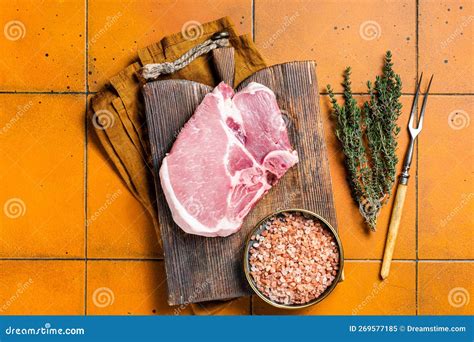 Fresh Raw Pork T Bone Chop Meat Steak On Cutting Board Orange