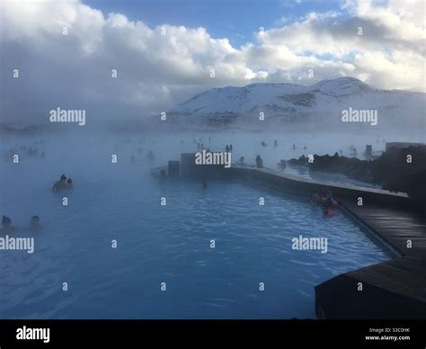 Blue Lagoon Iceland in winter with snow covered mountains in the ...