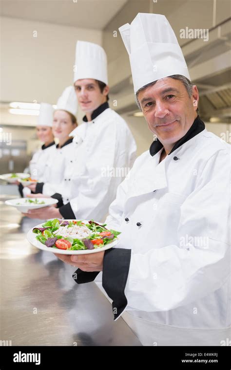 Smiling Chefs Presenting Their Salads Stock Photo Alamy