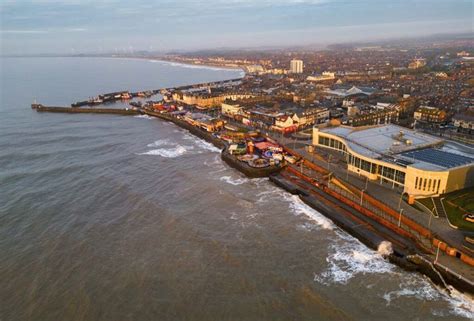 an aerial view of a city next to the ocean