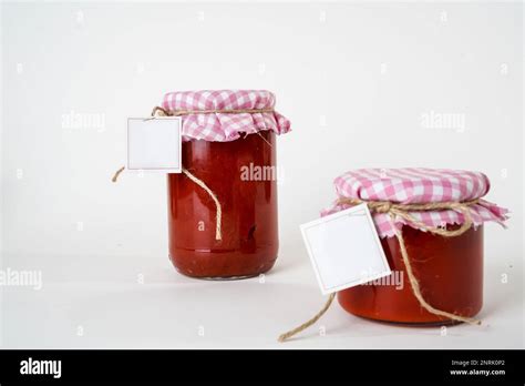 Two Canned Homemade Tomato Paste Jars With Empty Labels Isolated On