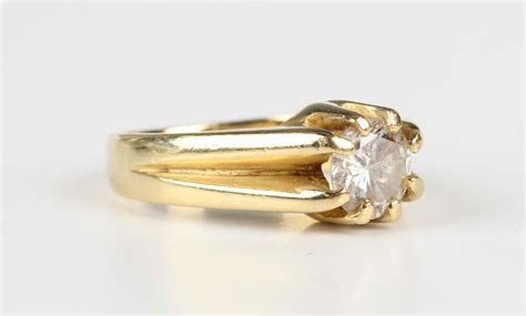 A Gold And Diamond Single Stone Ring Claw Set With A Circular Cut