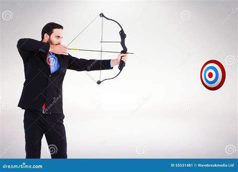 Composite Image Of Focused Businessman Shooting A Bow And Arrow Stock