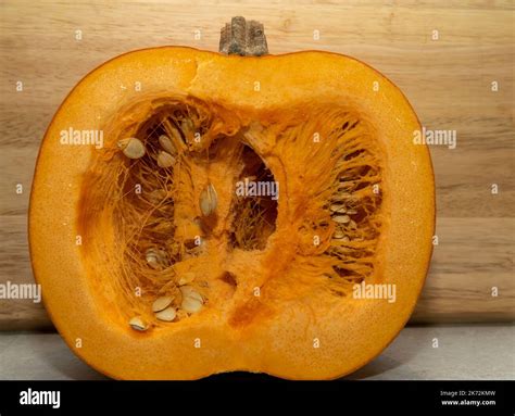 A Large Pumpkin Cut In Half Showing The Seeds And Pulp In The Middle