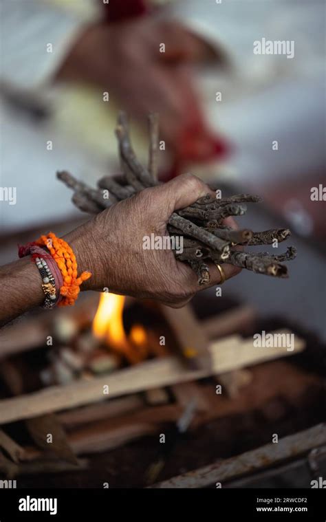 During An Indian Wedding A Priest Performs A Ritual With Fire And Wood