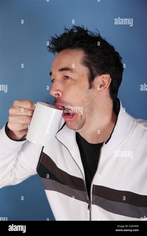 Young man has sleepy face before morning coffee Stock Photo - Alamy