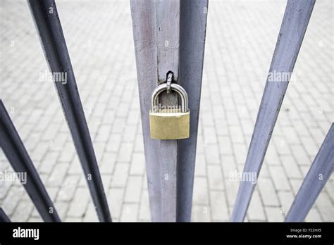 Padlock on a gate, security and protection Stock Photo - Alamy