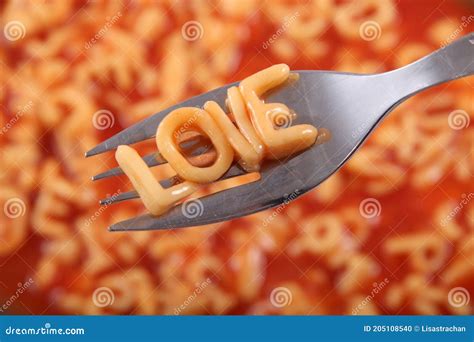 Spaghetti Letter Spelling The Word Love With The Letters Held Up On A