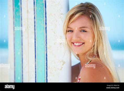 Enjoying The Moment Portrait Of A Pretty Blonde With Her Surfboard On