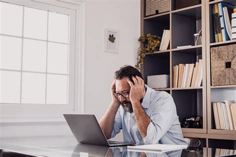 Premium Photo Man Using Mobile Phone While Sitting On Table