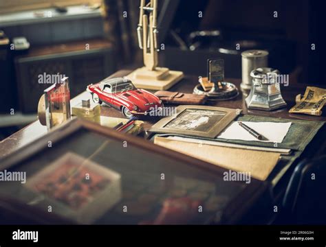 A Vintage Style Desk Featuring An Antique Toy Car A Cigarette Lighter