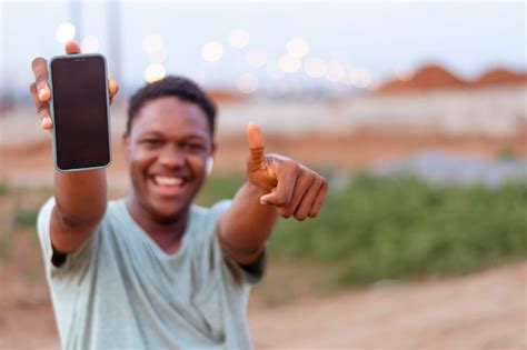 Premium Photo Happy African Man Smiling Showing Phone Display And