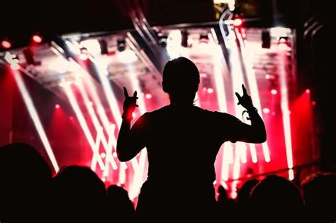 Premium Photo Silhouette Of Man With Raised Hands On Music Concert