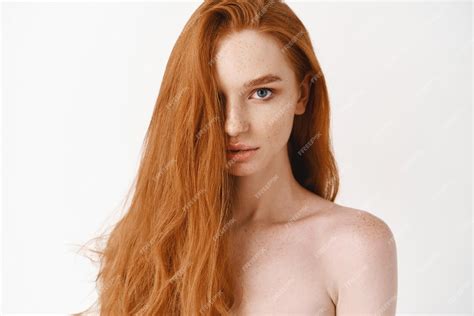 Free Photo Closeup Of Beautiful Young Woman With Long Healthy Red Hair Looking At Camera Pale