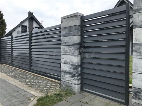 Modern Fence of Vertical Grey Metal Bars and Ranite Gray Tiles Stock ...