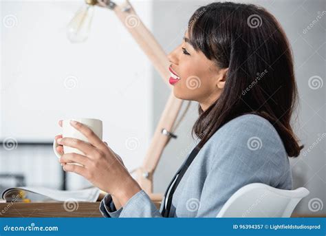 Young African American Businesswoman Holding Cup And Drinking Coffee