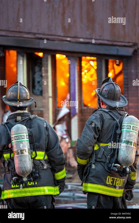 Detroit Michigan Firefighters Wait Before Entering A Burning Long